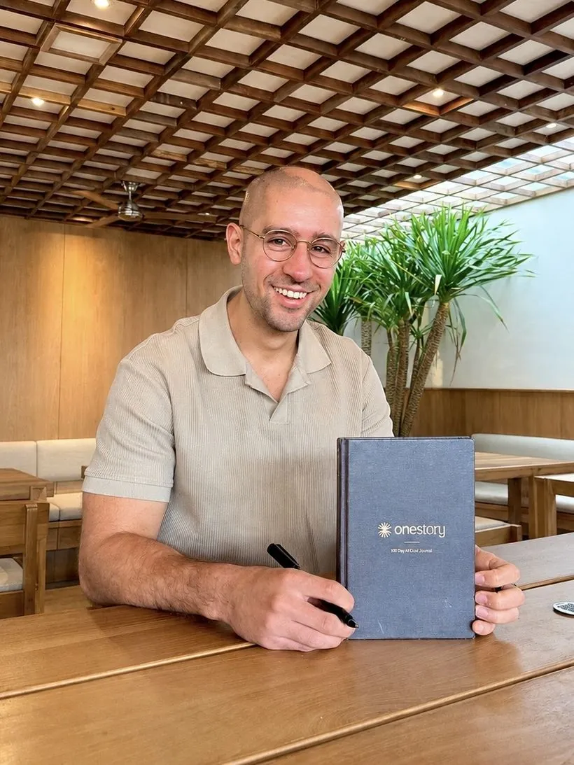 Logan Sneed holding the One Story journal