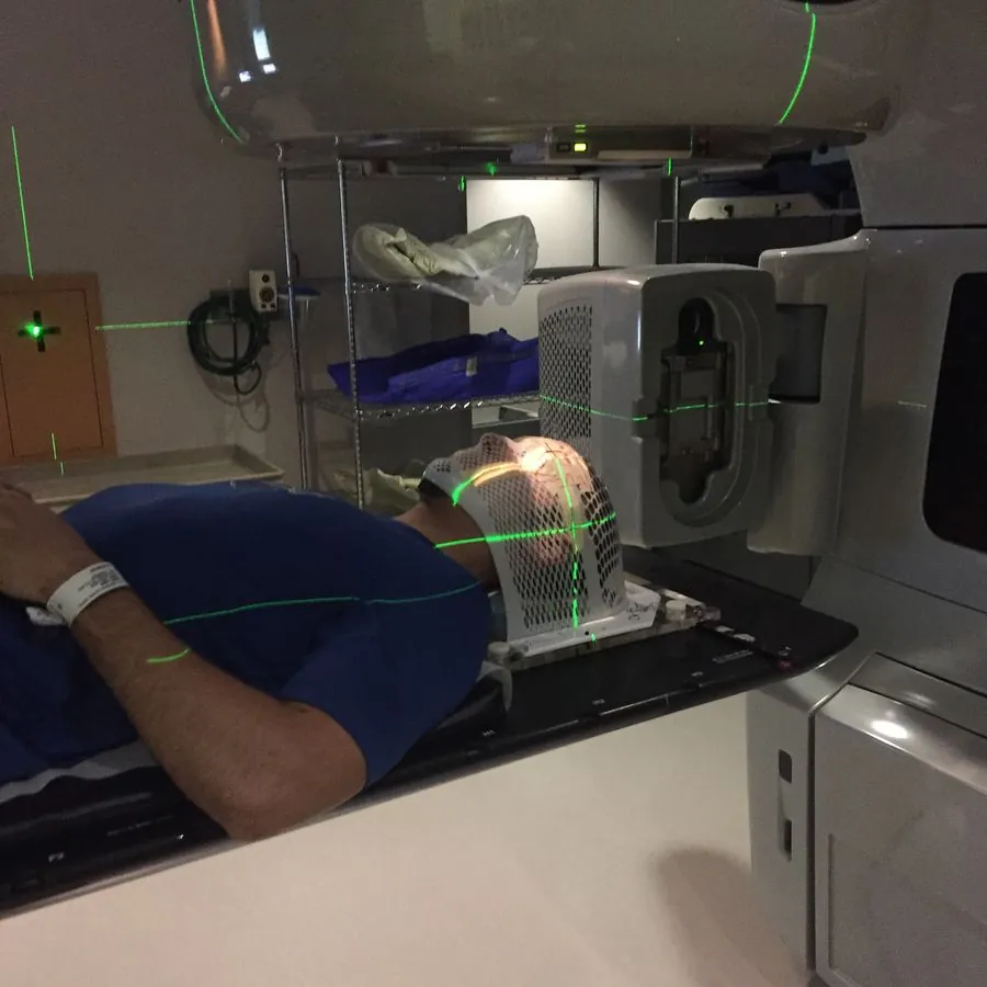 Logan in the radiation mask on the treatment table