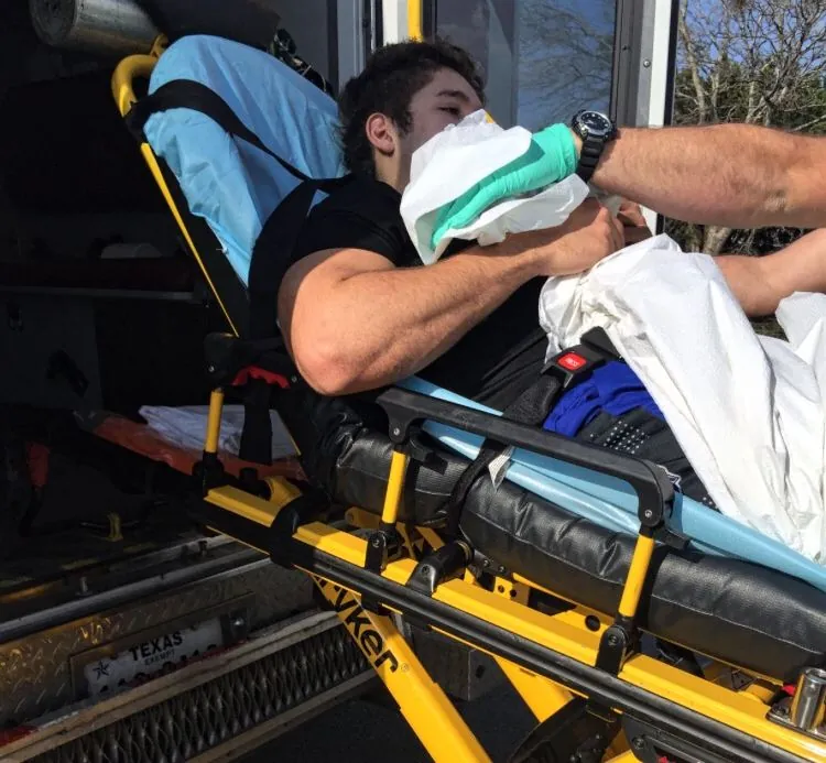 Logan being loaded into the ambulance