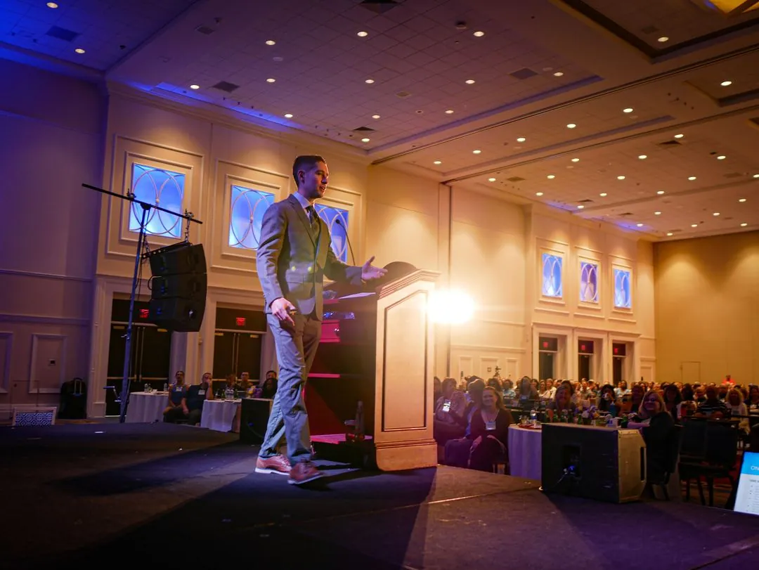 Logan speaking on a main stage