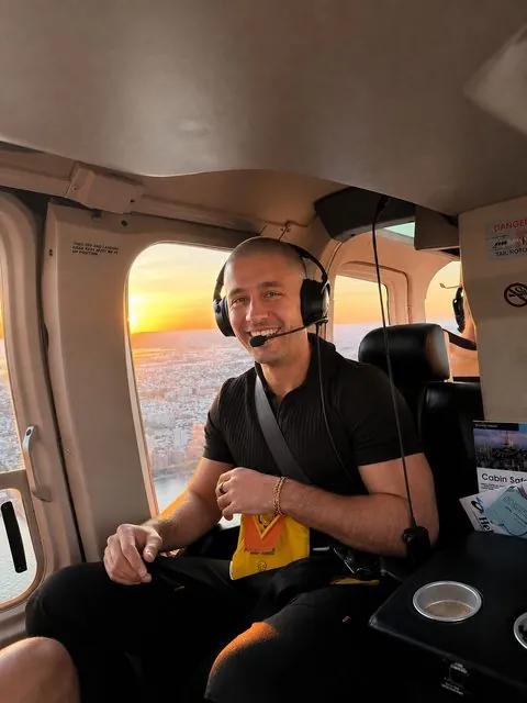Logan on a helicopter flight at sunset